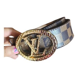 Louis Vuitton belt. Has classic Damier pattern and  gold LV buckle